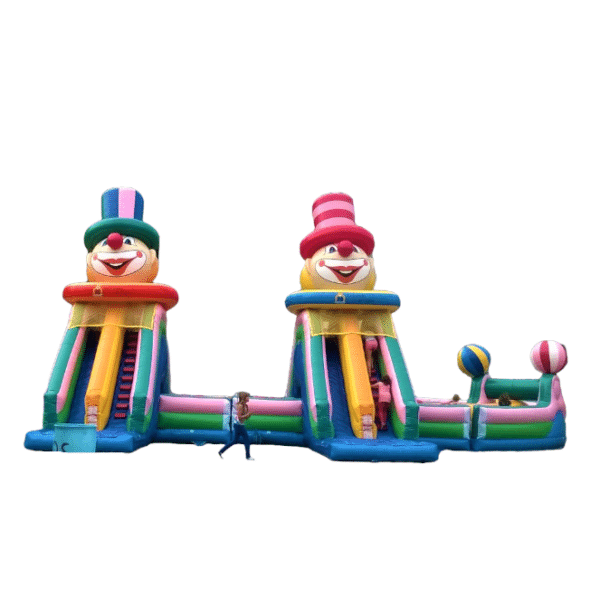 Parcours gonflable géant sur le thème des clowns, avec deux grandes structures colorées et des obstacles amusants. Conçu pour accueillir plus de 20 enfants, idéal pour des événements festifs ou carnavals. Dimensions impressionnantes de 21 mètres de longueur, 11 mètres de largeur et 7 mètres de hauteur. | Le Paradis de Tigrou